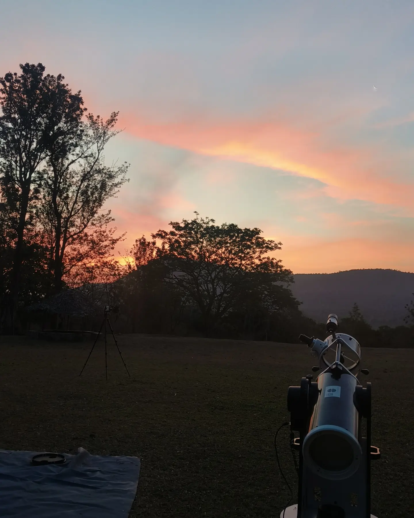A telescope framed against a rose-gold dusk sky at Sathyamangalam.